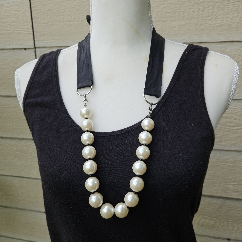 large white faux pearl necklace with black ribbon